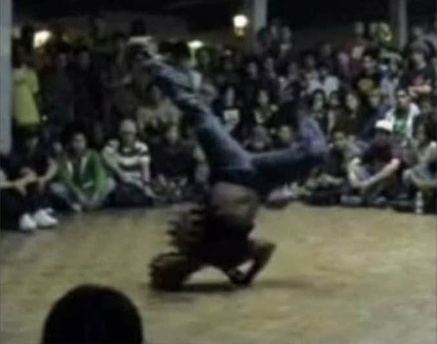 A Circus Runaways breaker mid power move before a crowd