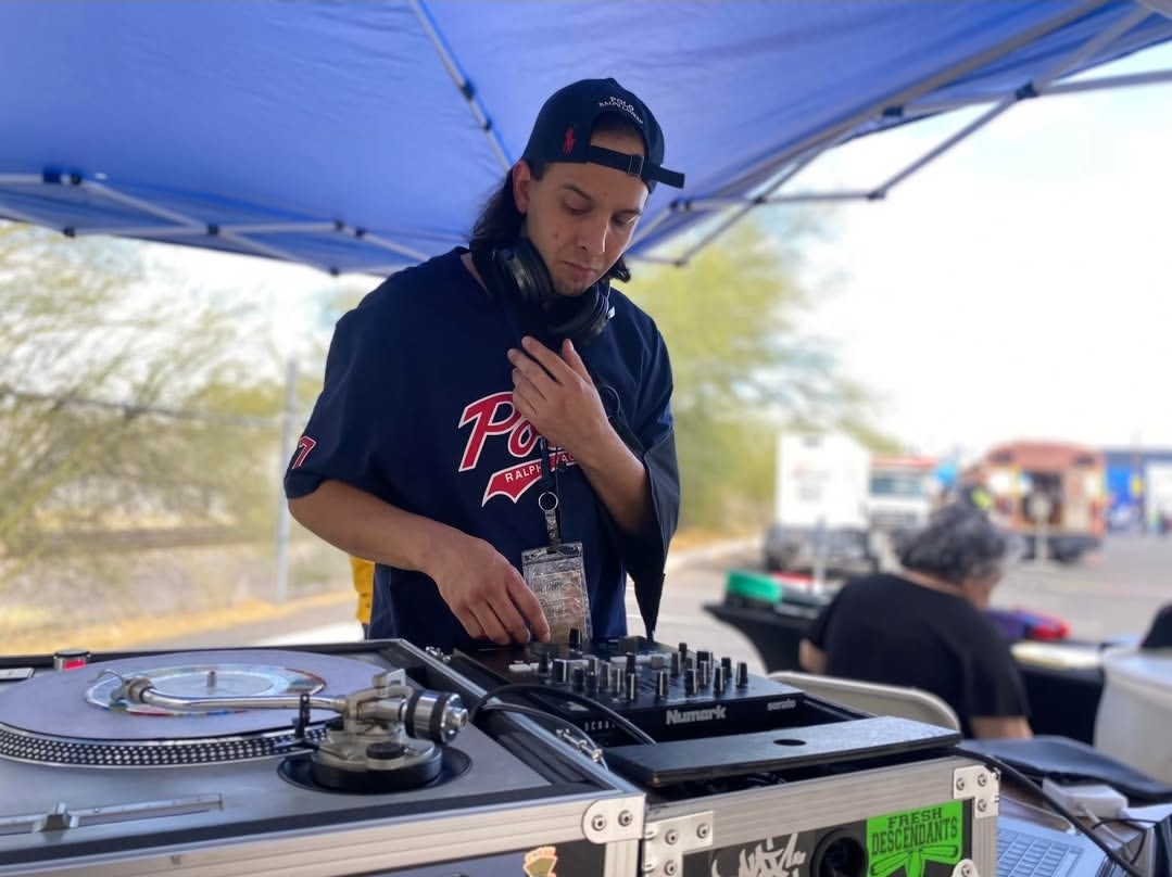 A DJ cutting records at a Circus Runaways event